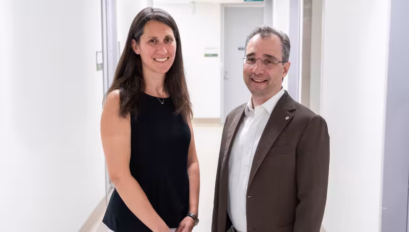 Two leads of Sinai Health's Mental Health and Addictions Program stand in a hallway at Mount Sinai Hospital