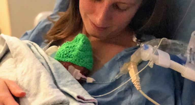 A woman holding her newborn infant