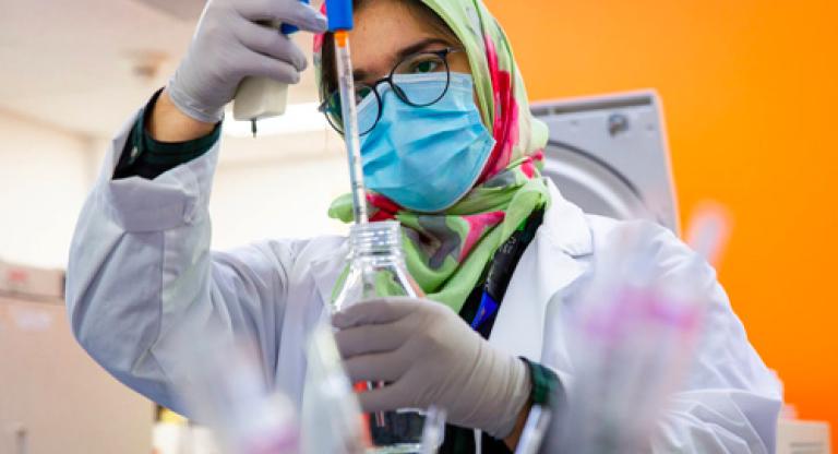 A woman using science equipment