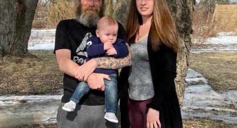 Jacquie Rombough with her partner and baby