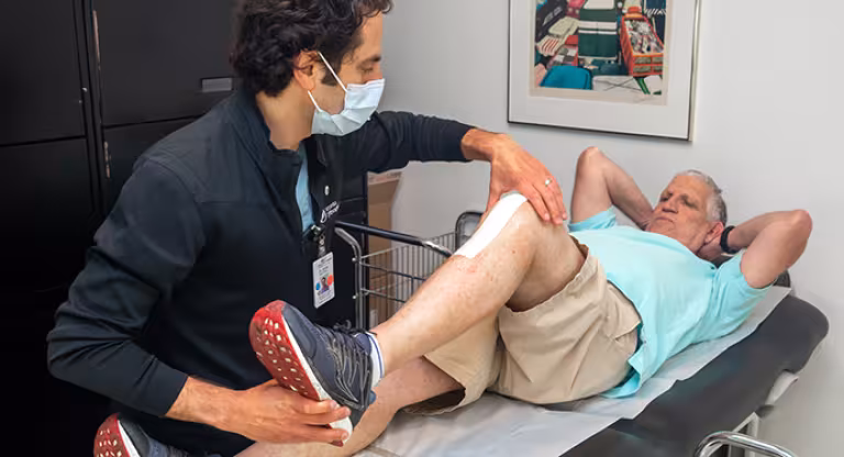 Dr. Jesse Wolfstadt, Orthopaedic Surgeon examines Gary Sandor 