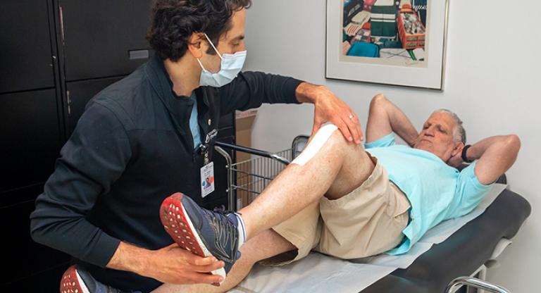 Dr. Jesse Wolfstadt, Orthopaedic Surgeon examines Gary Sandor 