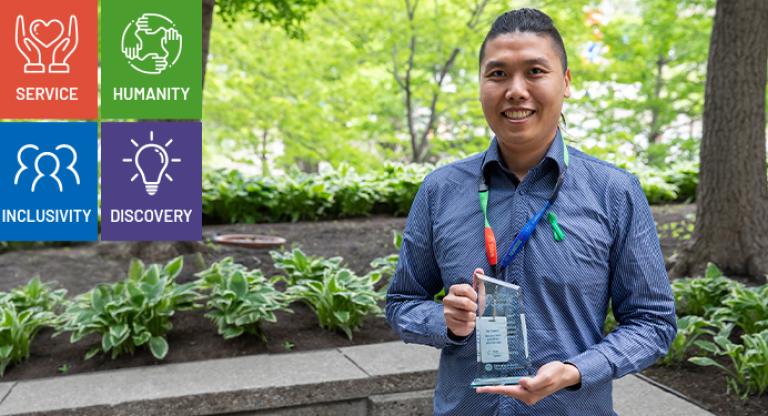 Joseph Leung is pictured in blue shirt holding his award