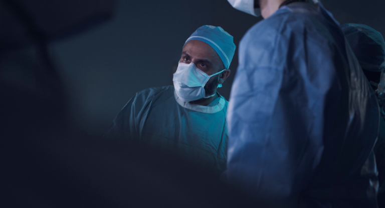 Picture of doctor in a mask looking at something