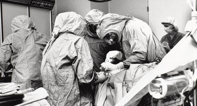 black and white photo of a surgical team operating on a patient
