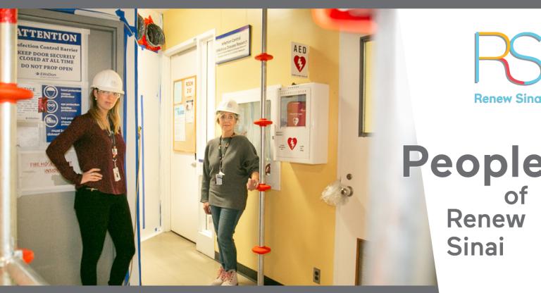 2 female Sinai Health employees wearing hard hats standing in a construction area within Mount Sinai Hospital