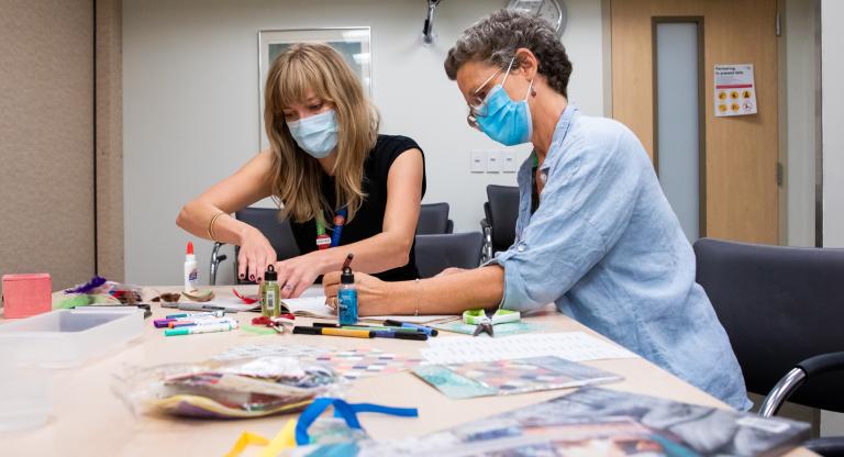 Two female Mount Sinai Hospital employees doing arts and crafts