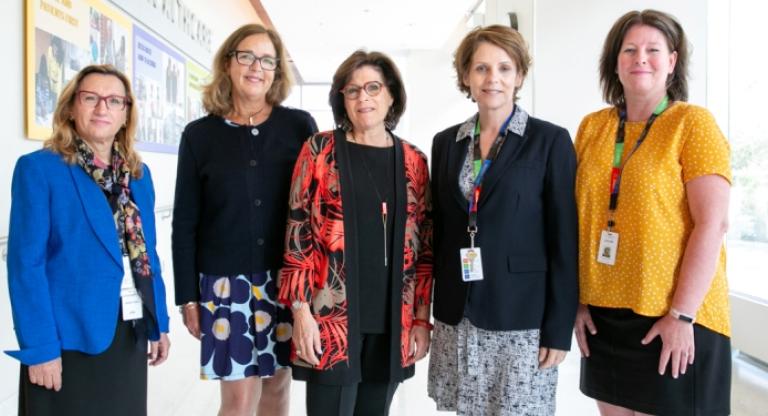 Five women standing in the Hennick Bridgepoint hallway.