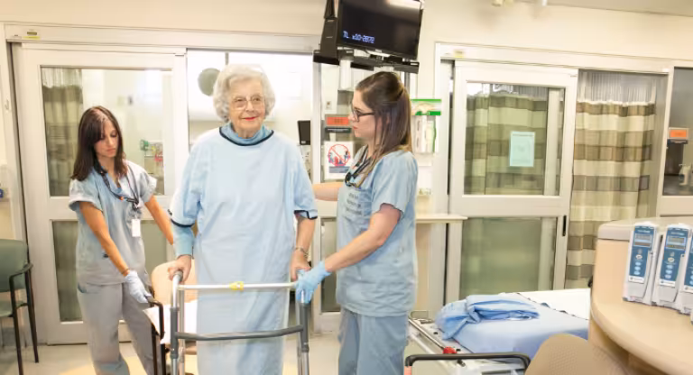 Older adult walks with assistive device 