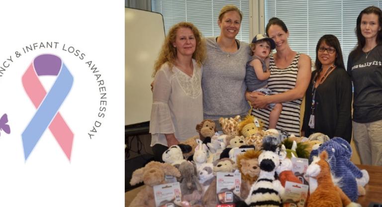 Group standing behind a pile of stuffed toys, a ribbon graphic on the left