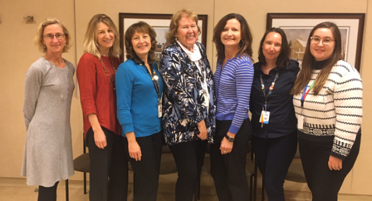 Seven women standing posing for photo at Mount Sinai Hospital.