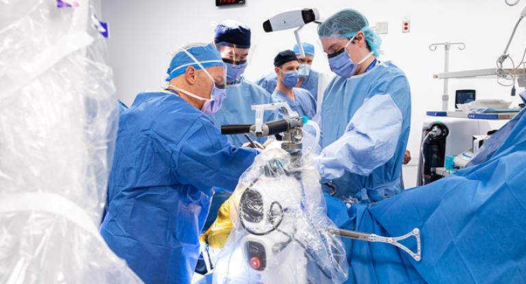 surgical team performs robotics assisted surgery