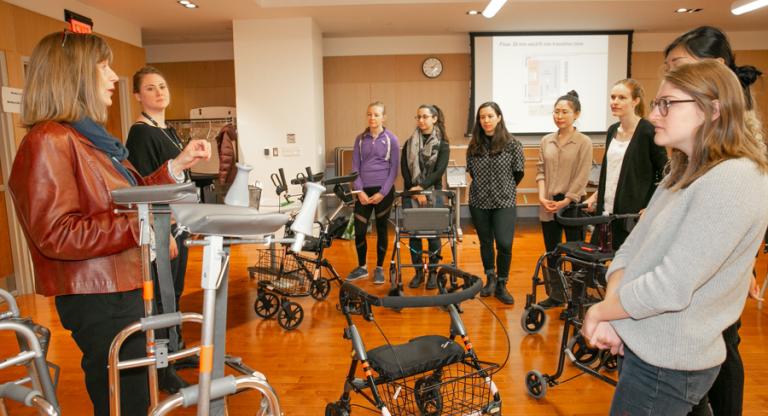 Occupational therapy students listening to instruction from an educator