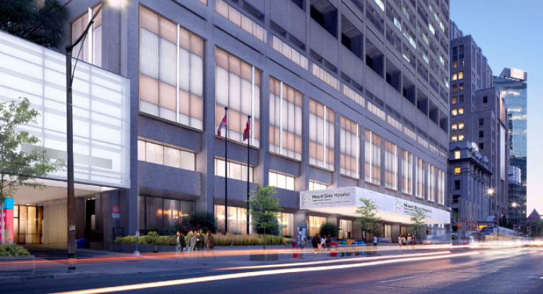 An exterior view of Mount Sinai Hospital with its windows illuminated in the evening.