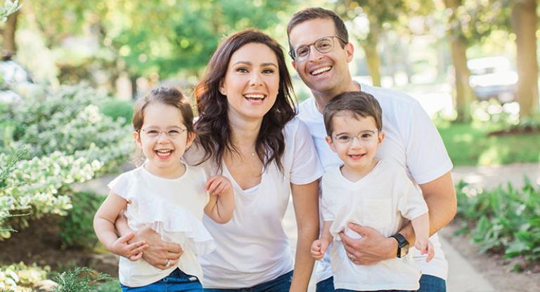 family of four standing outside
