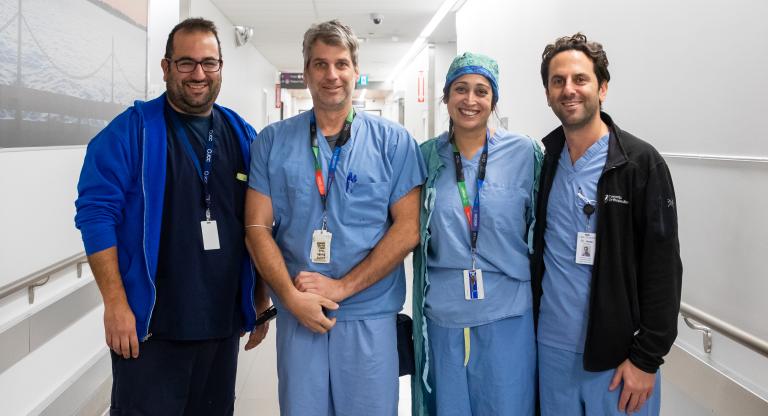 Physicians in blue scrubs in the operating room