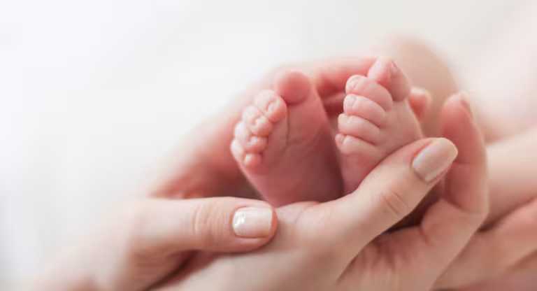 hands holding baby feet