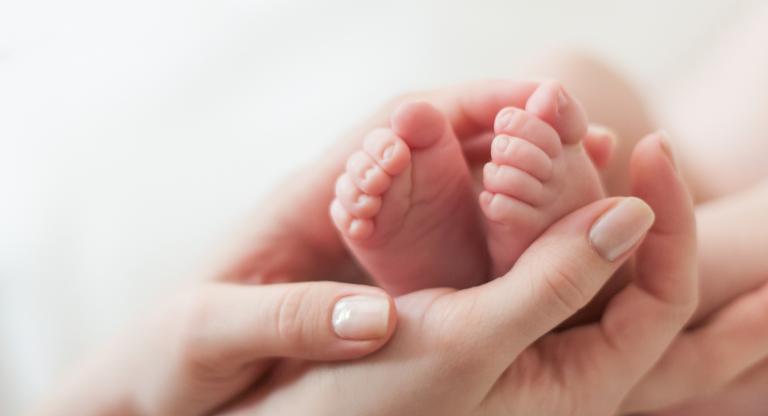 hands holding baby feet
