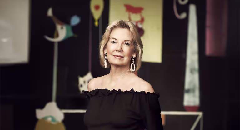 Photo of Hilary Weston wearing a black shirt in front of art sculptures