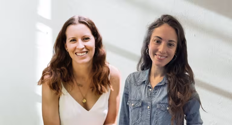 two smiling women, white background