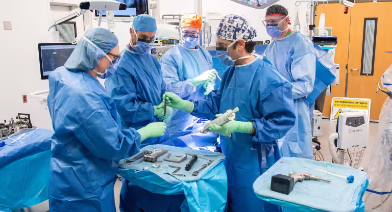 Members of the surgery team performing a procedure.
