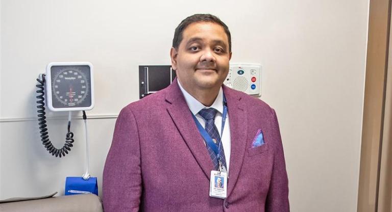 Dr. Darshan Brahmbhatt stands in exam room