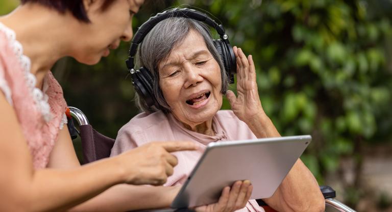 older woman wearing headphones singing