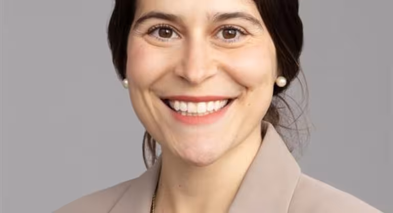 smiling woman in beige blazer
