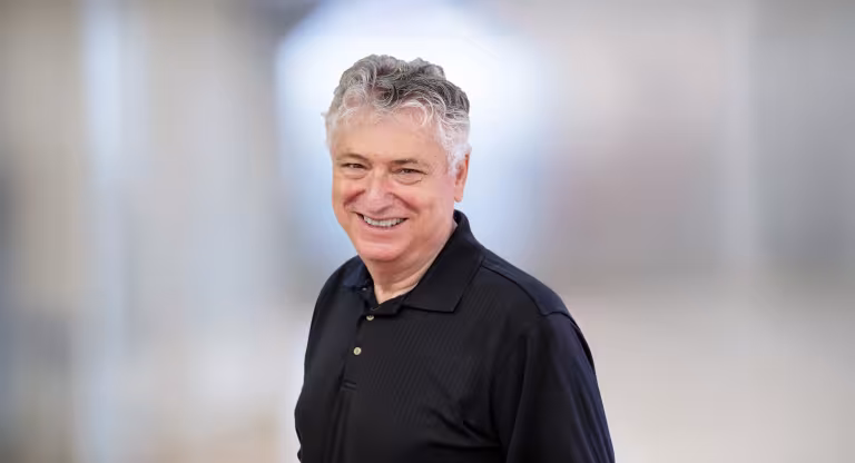headshot of man wearing black shirt