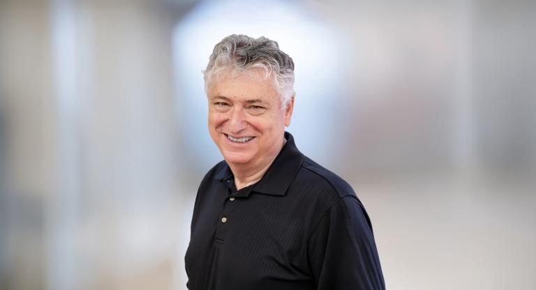 headshot of man wearing black shirt