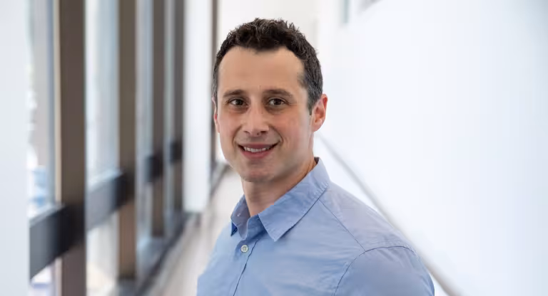 Dr. Ben-Yakov smiling in a blue shirt.