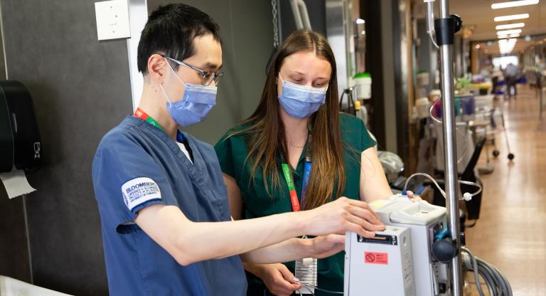 Two medical professionals checking equipment
