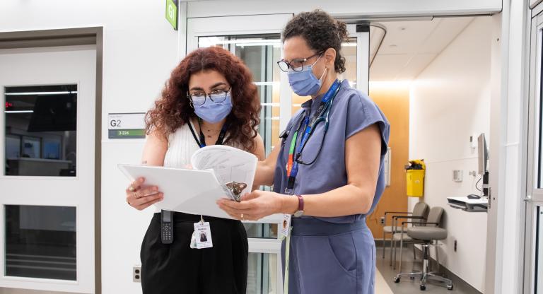 Two medical professionals in discussion for research purposes.