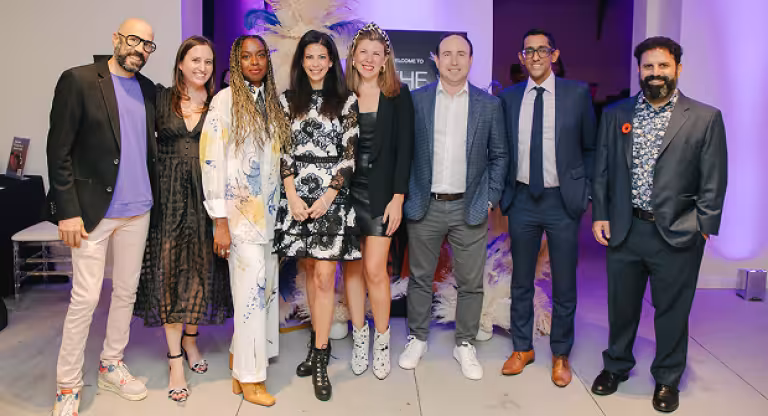 A group of young professionals, volunteers of Leadership Sinai, pose together at a Sinai Health Foundation event