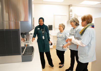 Volunteers tour the new unit with the new Caregiver and Patient Support Co-ordinator.
