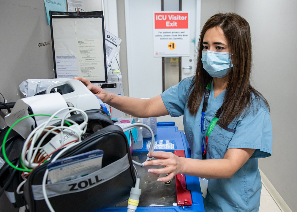 ICU Nurse handling an equipment