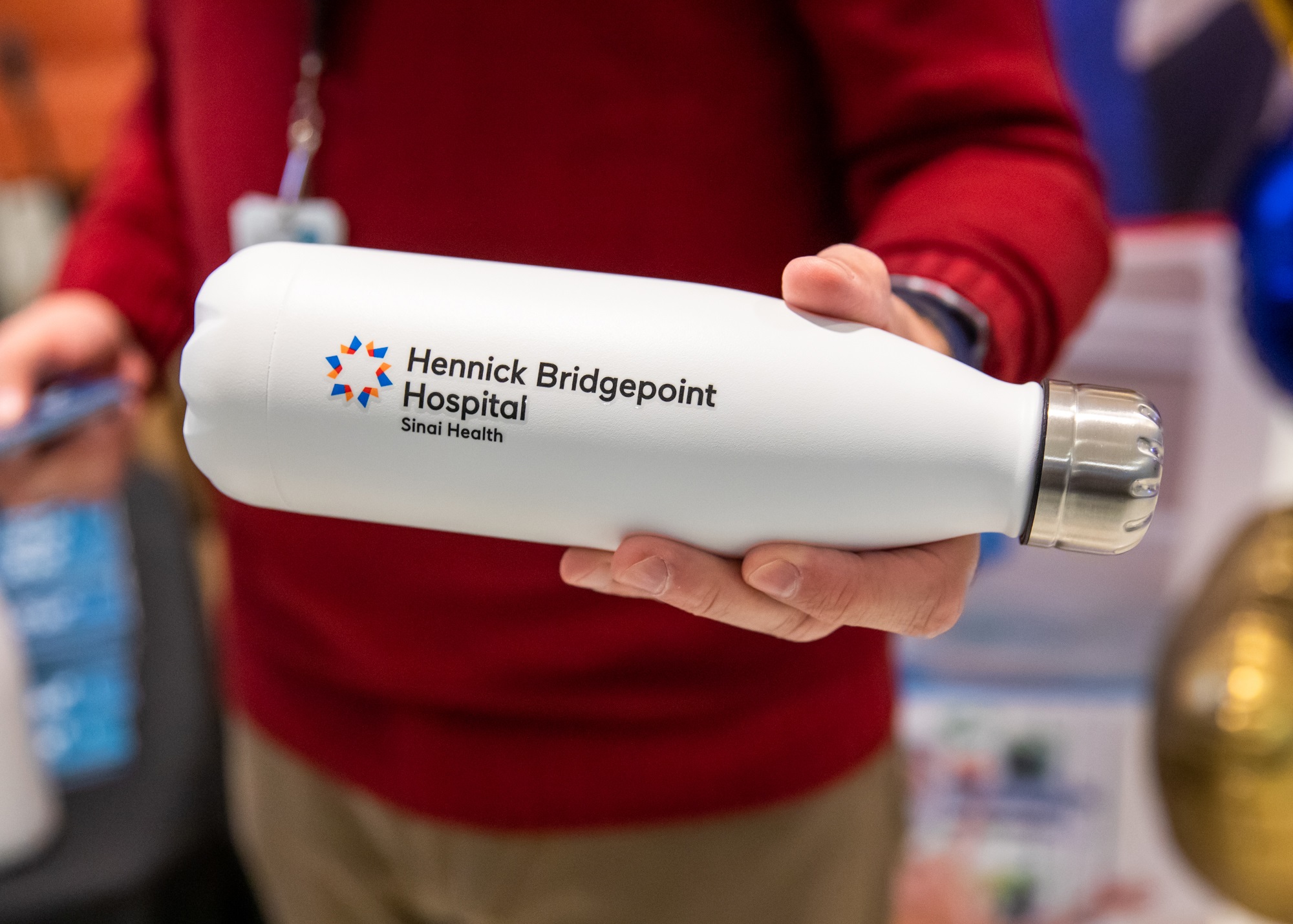 A close-up photo of a metal water bottle with a logo that says Hennick Bridgepoint Hospital and the words Sinai Health in smaller letters below.