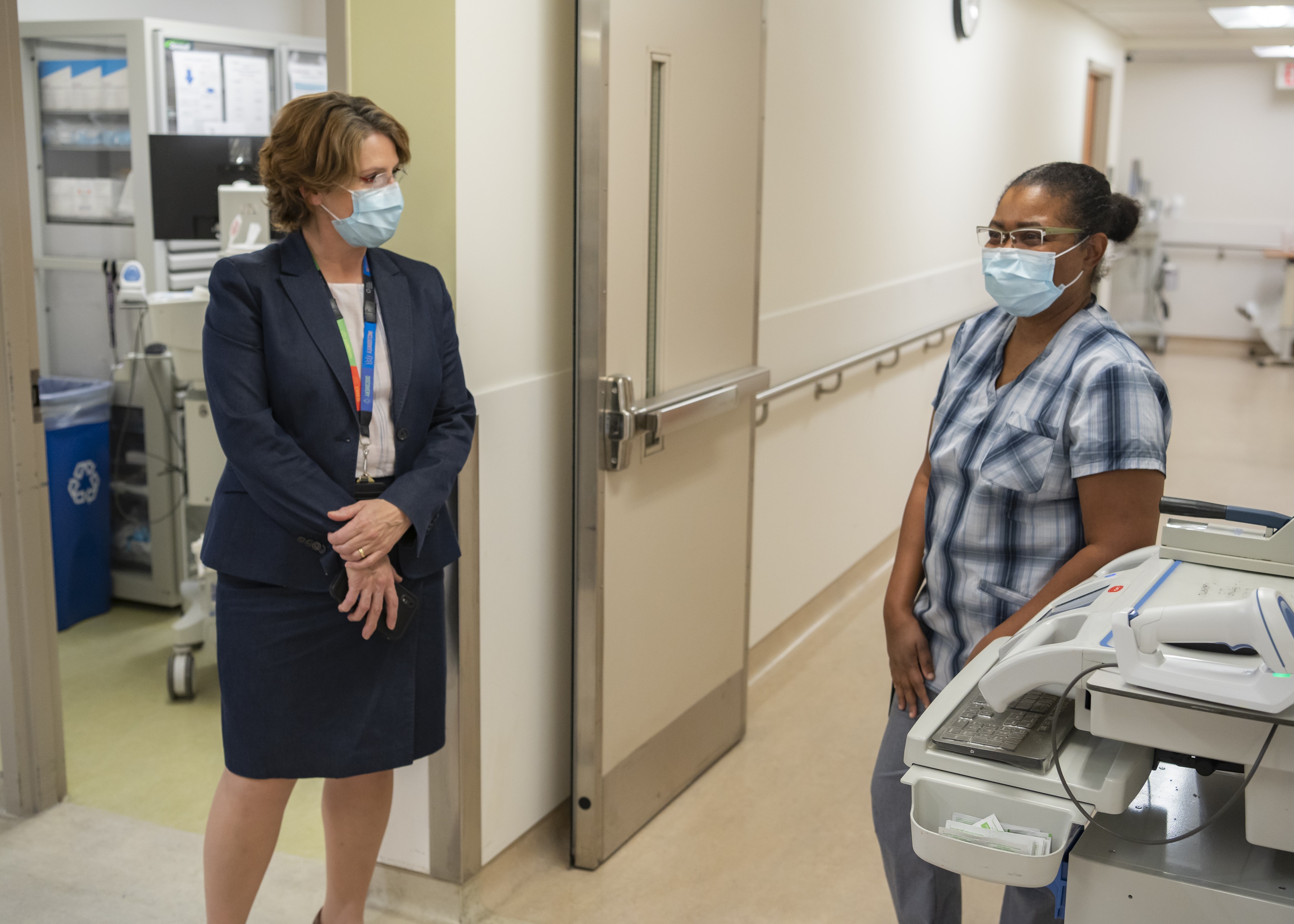Kate Wilkinson, a vice president at Sinai Health speaks with a health care worker on a unit at Hennick Bridgepoint hospital